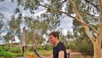 Sitting Down Reading an iPad in Alice Springs