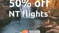 text of 50% off NT flights on top of image of waterfall with woman on rock