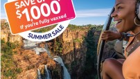 Image of woman looking out from helicopter over a waterfall with a logo in left hand corner