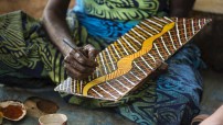 image of womans hand doing a bark painting