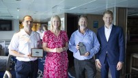 image of captain with others at plaque presentation