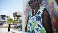 woman looking up at mural of woman in katherine