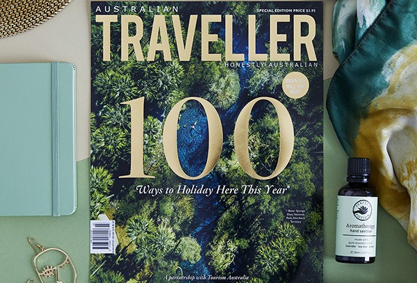 flat lay showing front cover of Australian Traveller magazine with top 100 trips