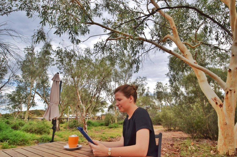 Sitting Down Reading an iPad in Alice Springs