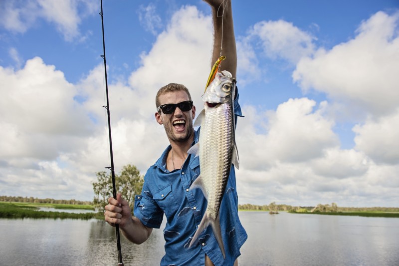 Man holding fish that he caught