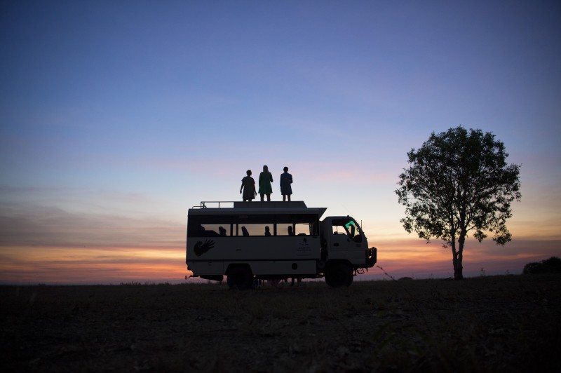 People standing on truck watching sunset at Wildman Wilderness Resort