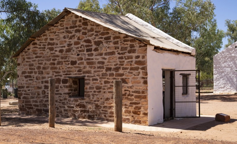 image of old building facing wall is stone and front wall is whitewashed