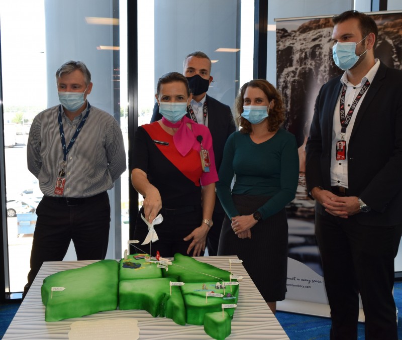 image of large green cake shaped like australia with spokespeople behind