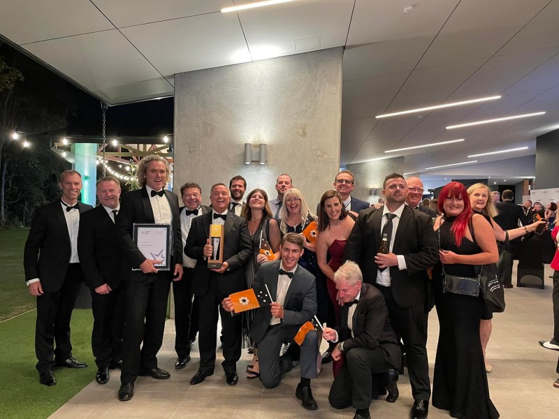 image of men and women dressed in suits and gowns at awards night