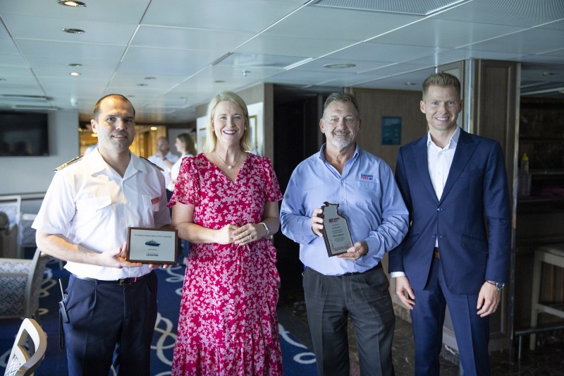 image of captain with others at plaque presentation