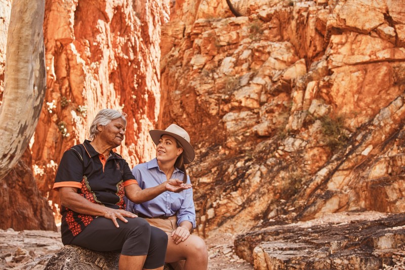 Elder talking to tourist at Standley Chasm